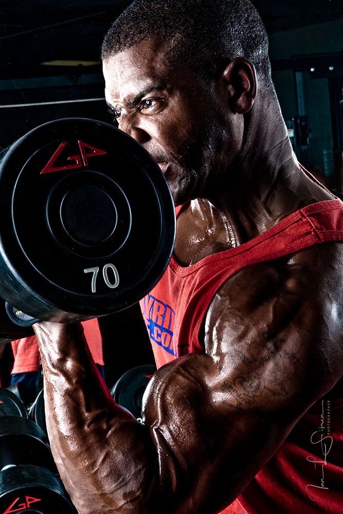 Bodybuilders Xavisus Gayden working out during our photo shoot in the gym